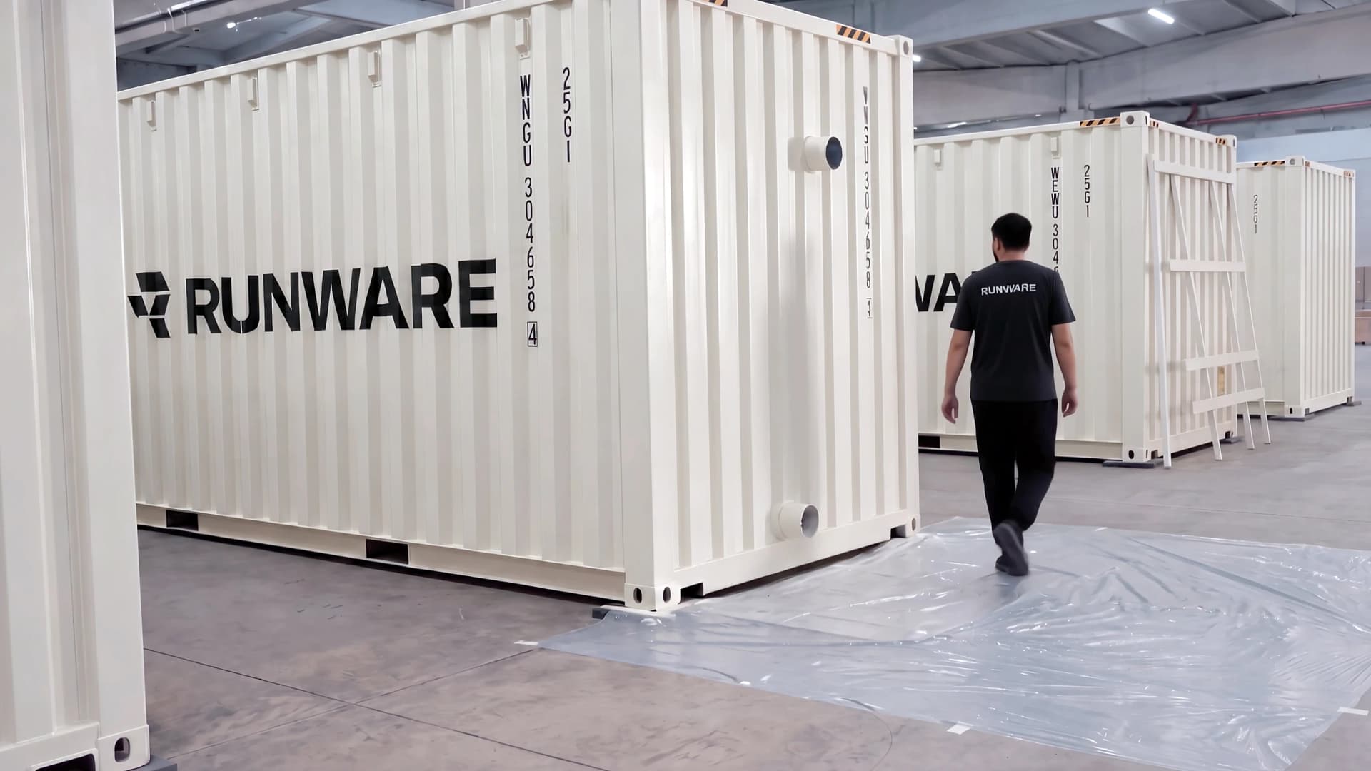 Runware-branded Sonic Pod shipping containers on the factory floor