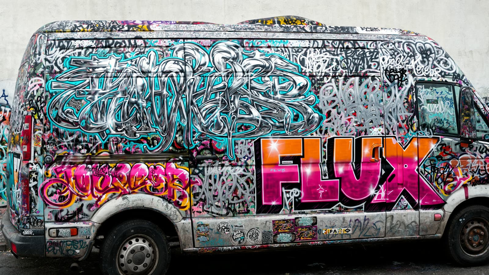 A graffiti-covered van, an example from Black Forest Labs