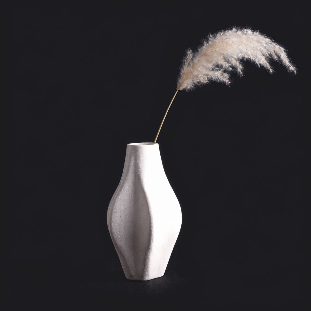 A minimalist ceramic vase on a pure black background