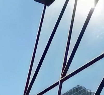 The same crop after enhancement, with the beams meeting the sky cleanly and no pale outline