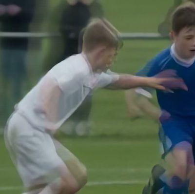 The same crop declared progressive, the stripes replaced by smeared ghosting along the players