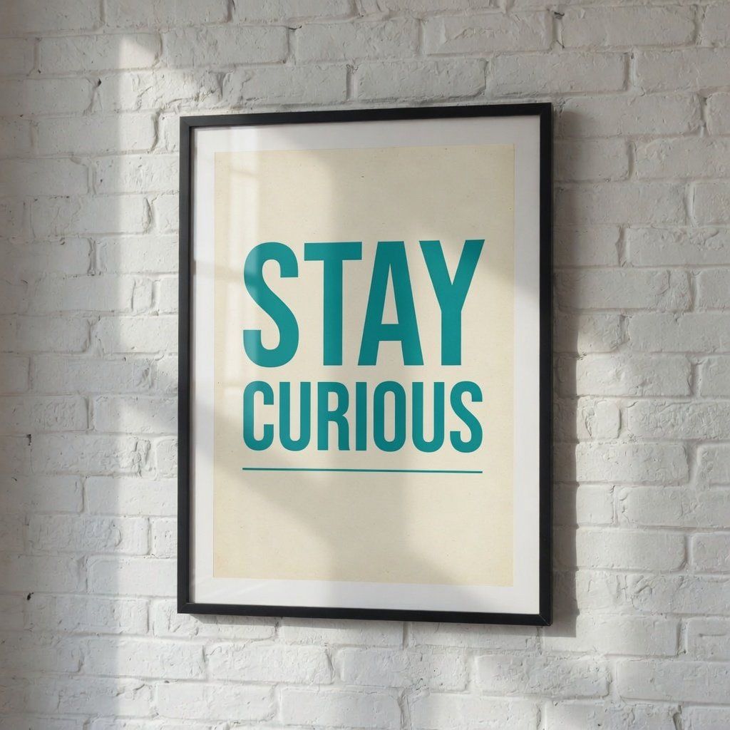 The same framed poster on a white brick wall now reading STAY CURIOUS in teal letters