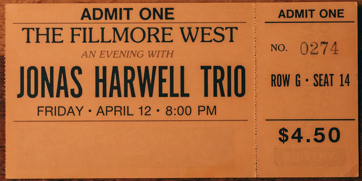A vintage 1970s concert ticket reading 'ADMIT ONE / THE FILLMORE WEST / AN EVENING WITH / JONAS HARWELL TRIO / FRIDAY · APRIL 12 · 8:00 PM' with a perforated right stub showing the ticket number, row, seat, and price, every element positioned by bbox coordinates