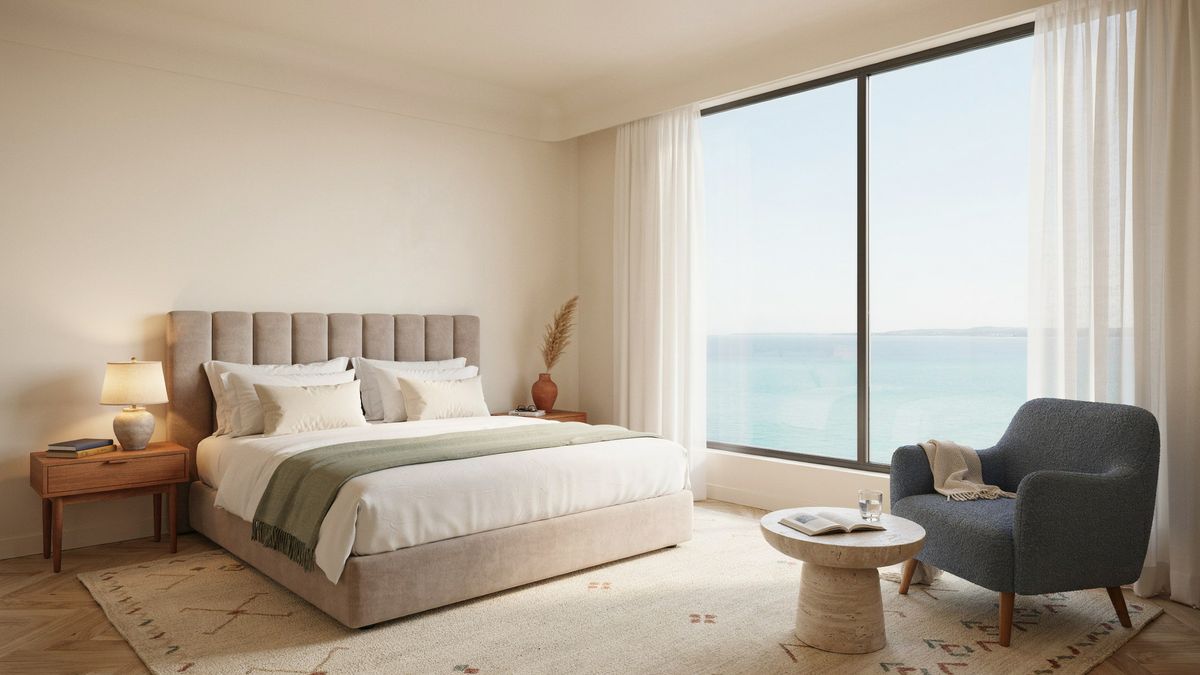 A hotel room with a large window onto the sea, a gray armchair and a bed with a green throw, generated with Magic Prompt off