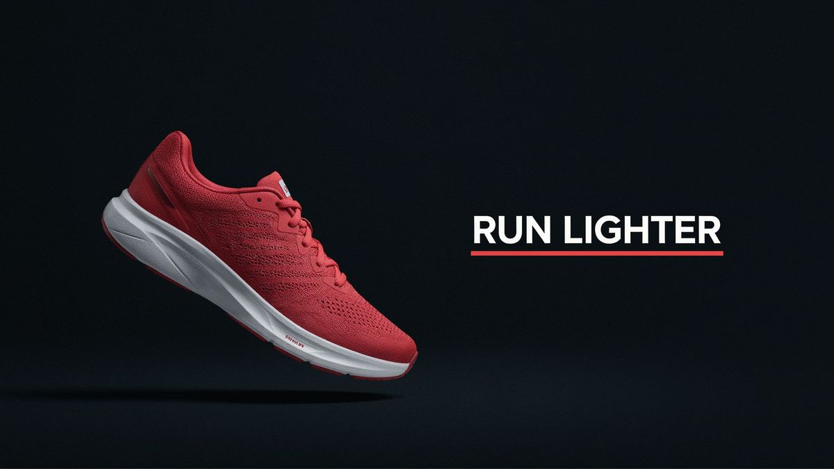 A wide billboard mockup of a coral and white running shoe on a charcoal background with a bold RUN LIGHTER headline and a coral underline