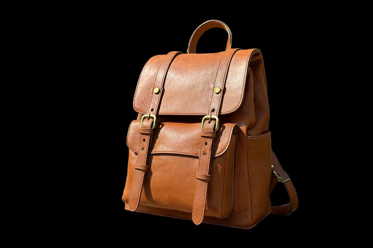 The same tan leather backpack cut out with no bench, no park, and no shadow behind it