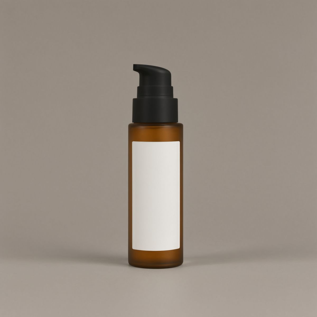 The same bottle in amber glass with a matte black pump on the same grey backdrop
