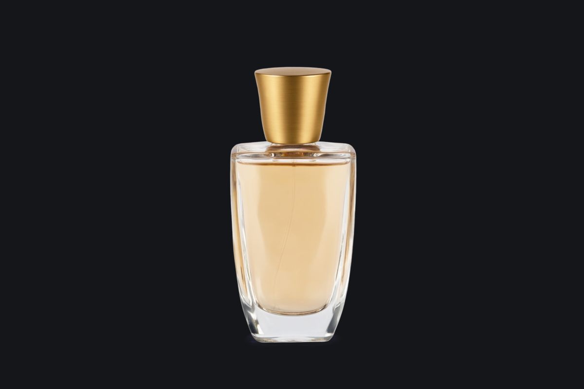 The same perfume bottle placed on a near-black background, its glass still pale