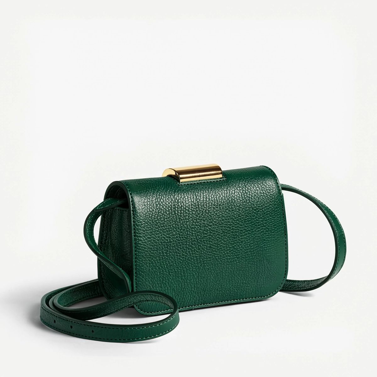 The same bag as a colourway variant in deep forest green pebbled leather on the same off-white studio backdrop