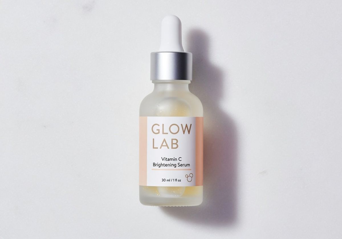 A minimalist skincare bottle with the label GLOW LAB Vitamin C Brightening Serum in clean sans-serif typography on a marble surface