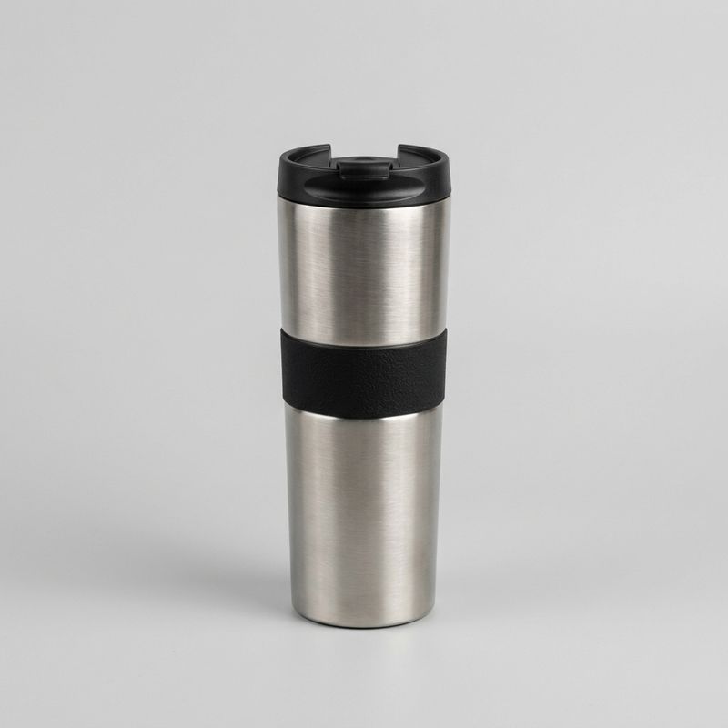 Product photograph of a tall brushed-stainless-steel coffee tumbler with a black silicone grip band, on a plain pale grey background
