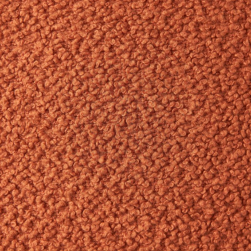 A close-up swatch of looped terracotta boucle fabric