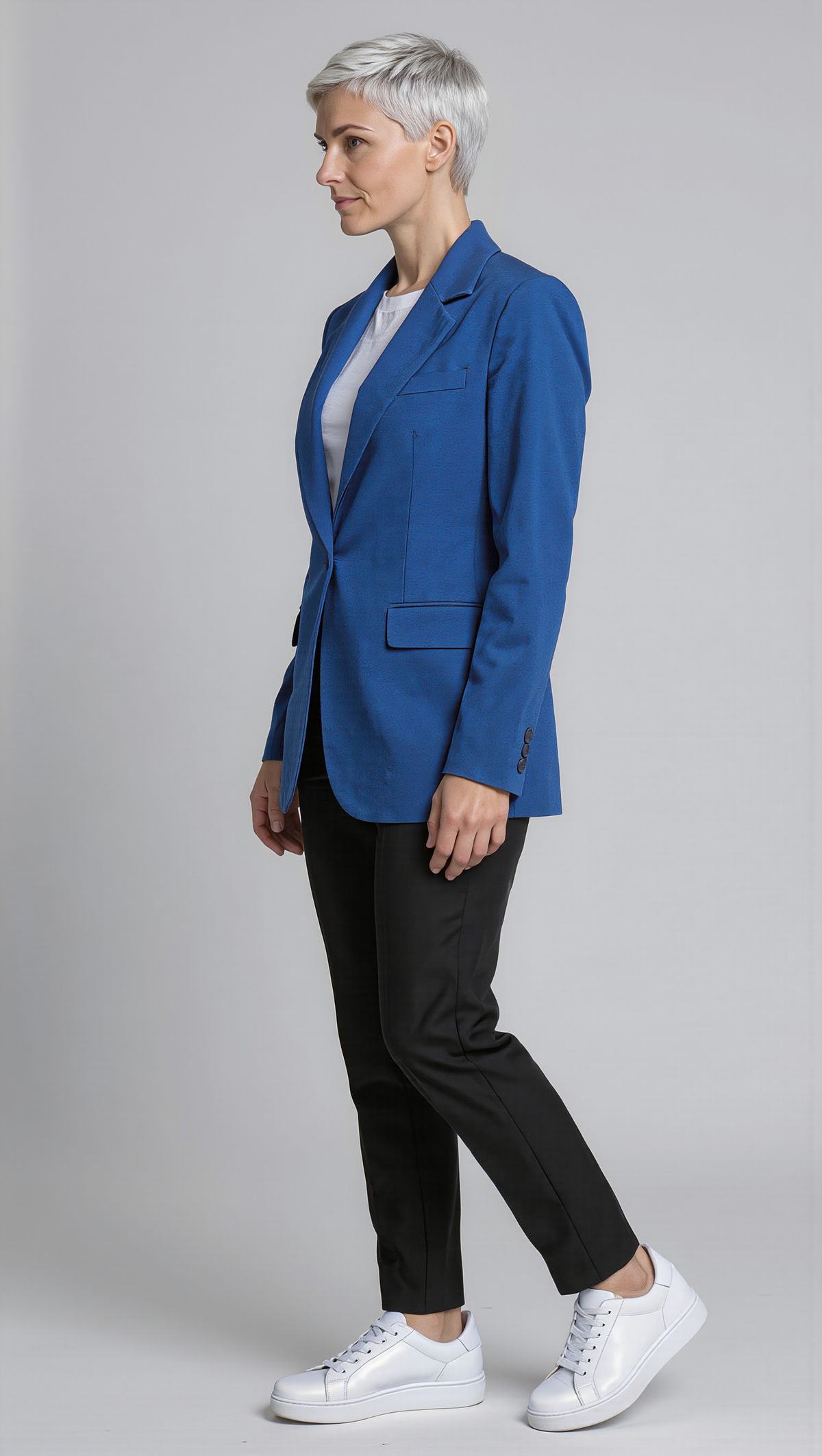 The same woman in a three-quarter view turned to her left against a light gray backdrop