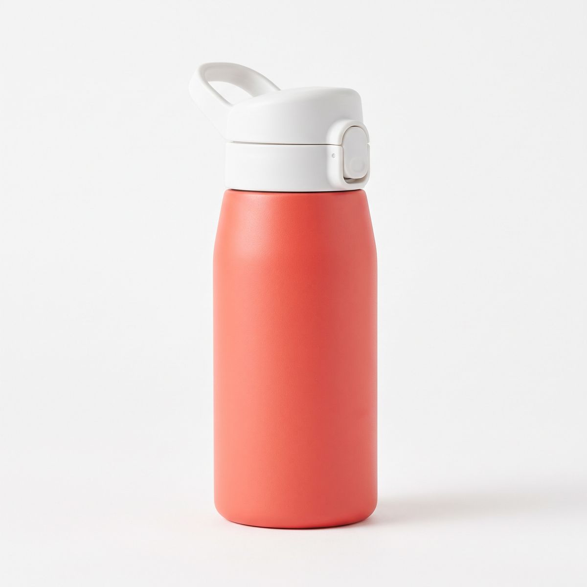 A coral stainless steel kids' water bottle with a white flip lid on white