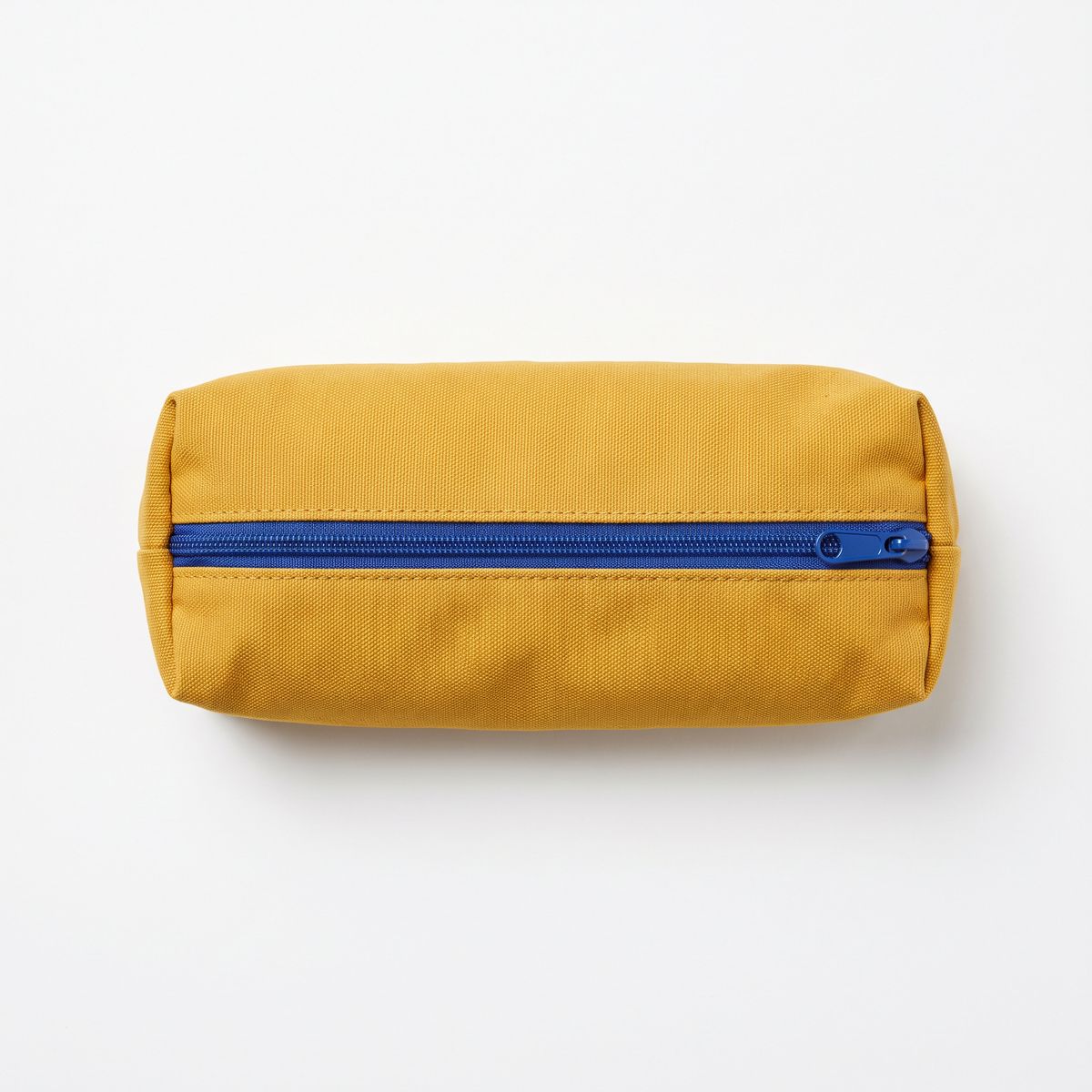 A mustard yellow canvas pencil case with a cobalt blue zipper on white