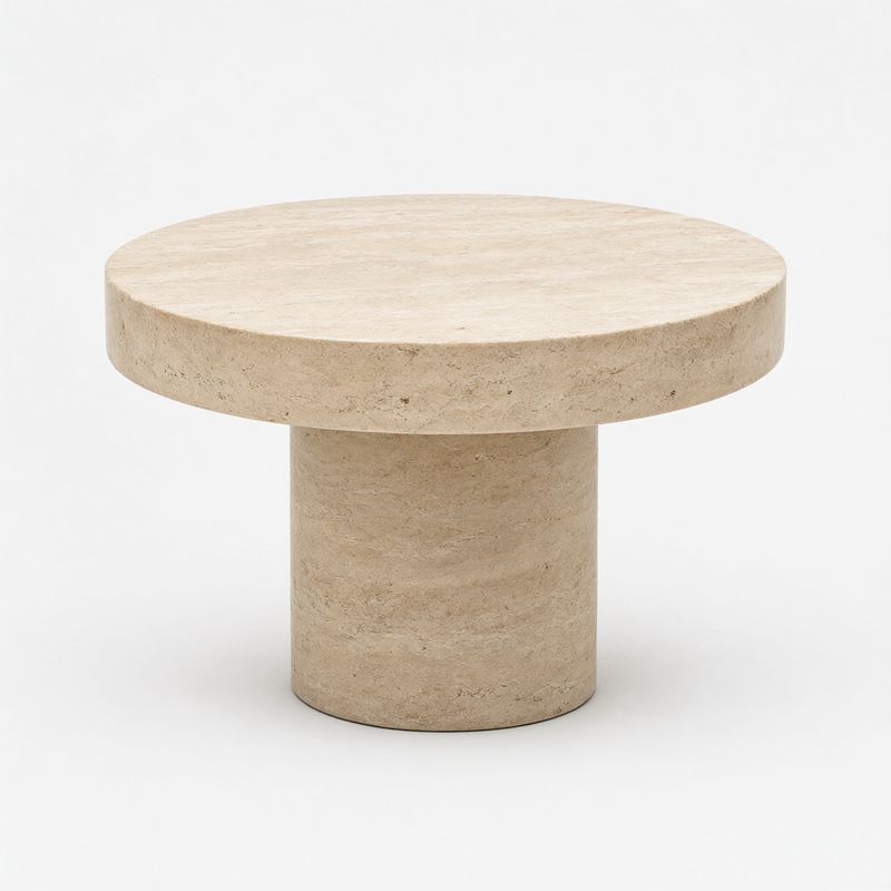 A round travertine coffee table on a cylindrical travertine pedestal on white