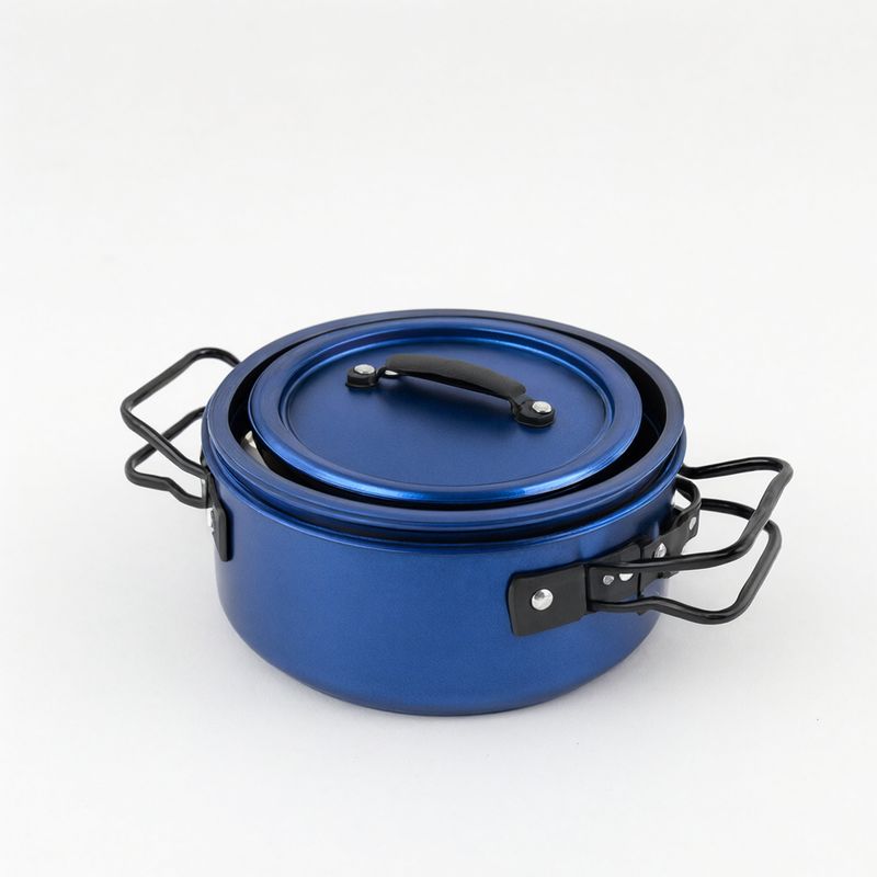 A blue anodized aluminum cook pot with a lid and folding black handles on white