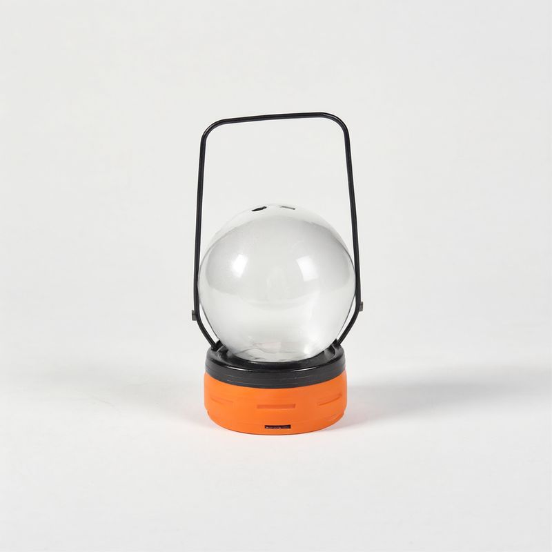A camping lantern with a frosted globe, an orange rubber base, and a black wire handle on white