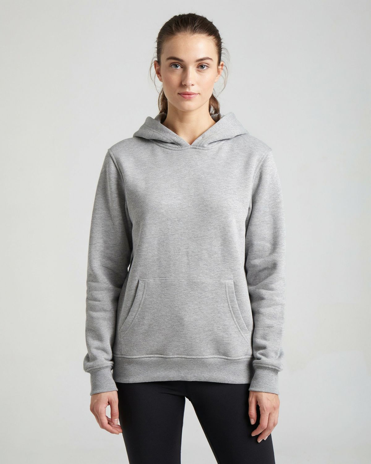 A woman in a plain heather gray hoodie against a light gray backdrop, with the masked area over the chest highlighted