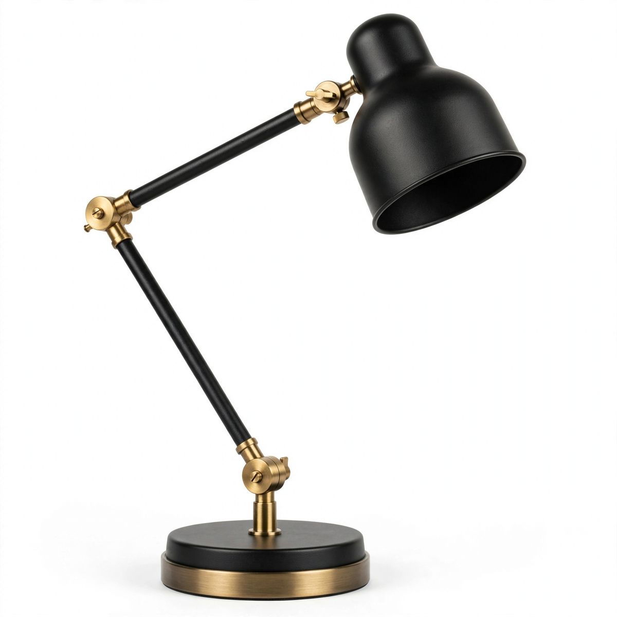 A matte black articulated desk lamp with a brushed brass stem and a weighted round base, three-quarter view on a plain white background