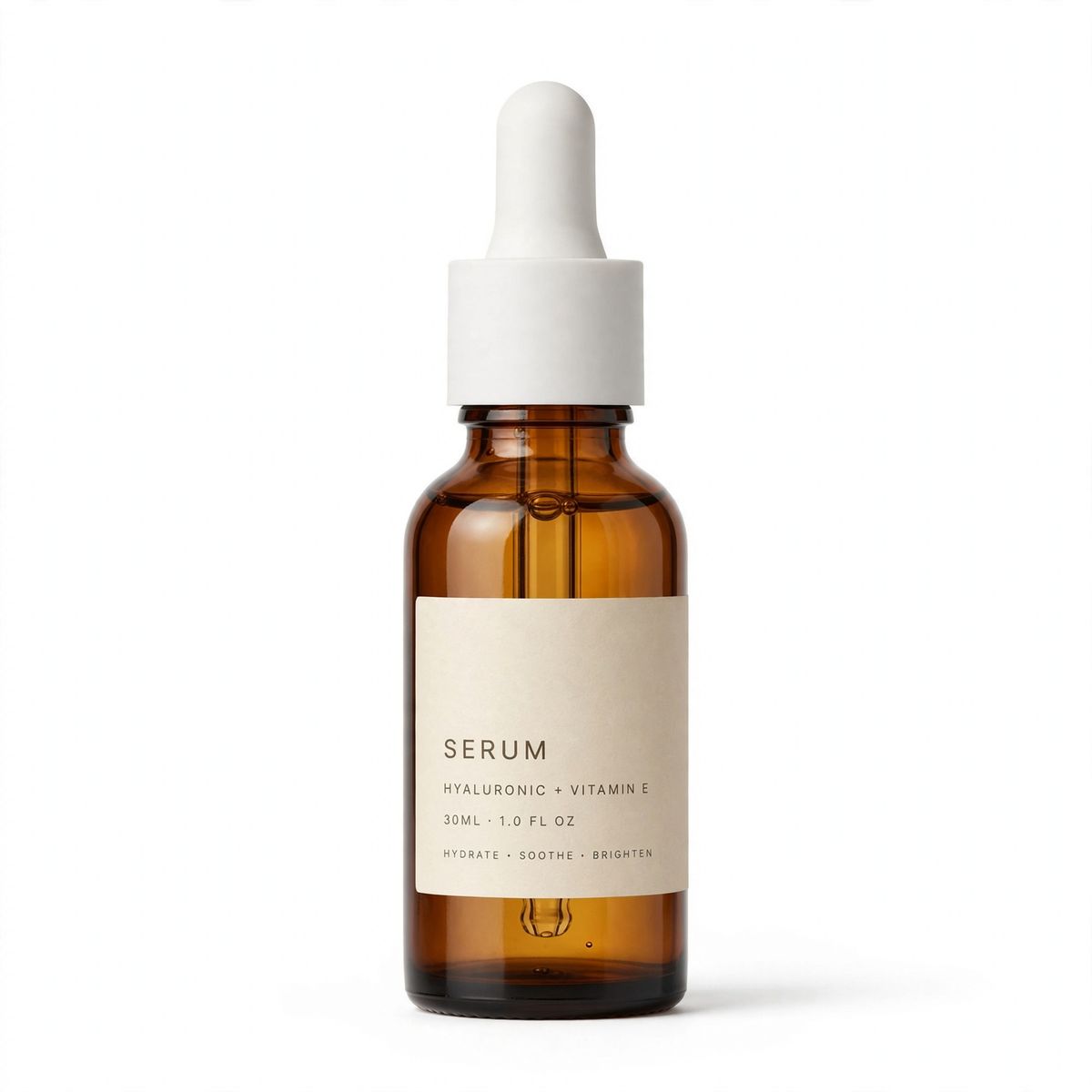 An amber glass serum bottle with a matte white dropper cap standing upright on a white background