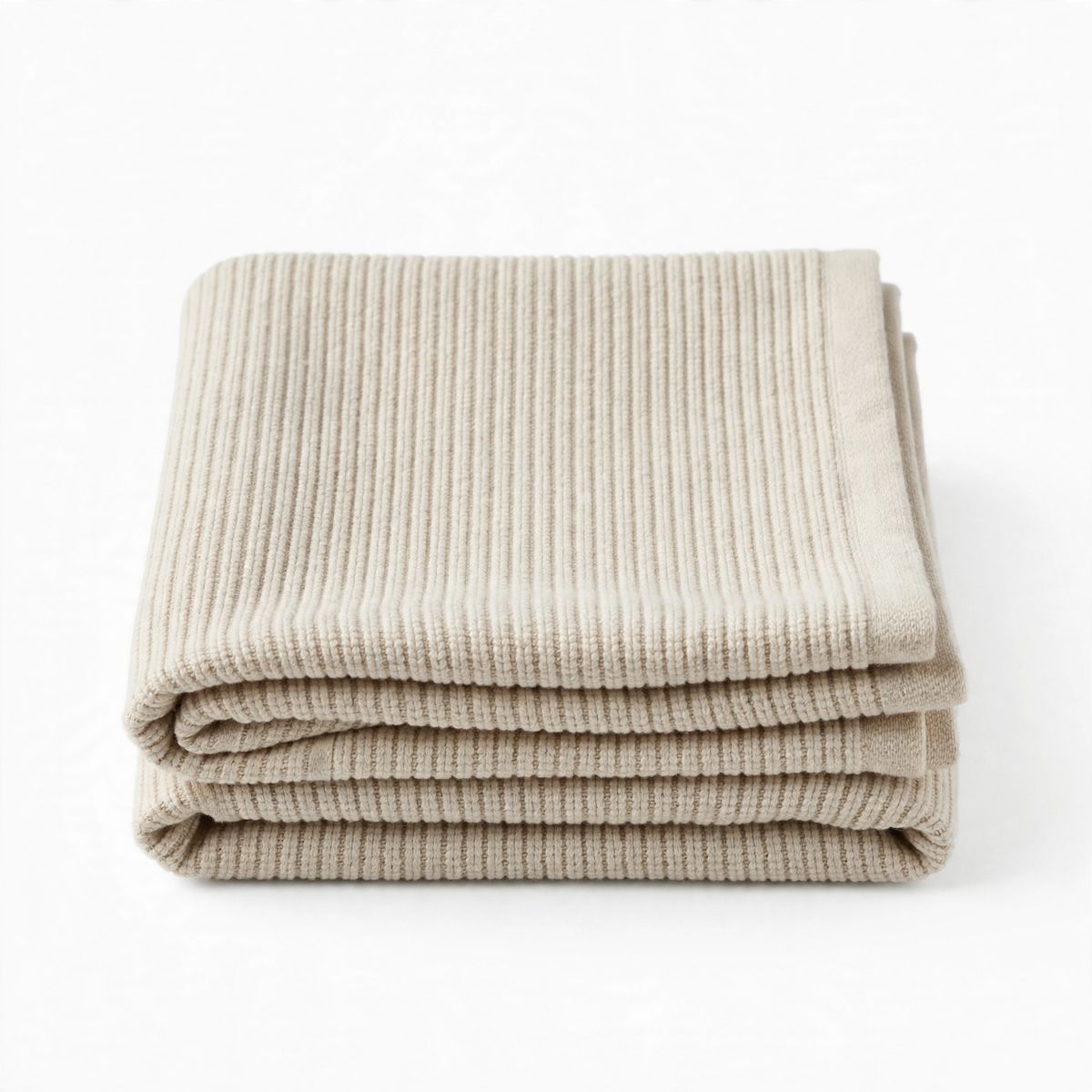 A neatly folded ribbed cotton hand towel in oatmeal beige on a white background