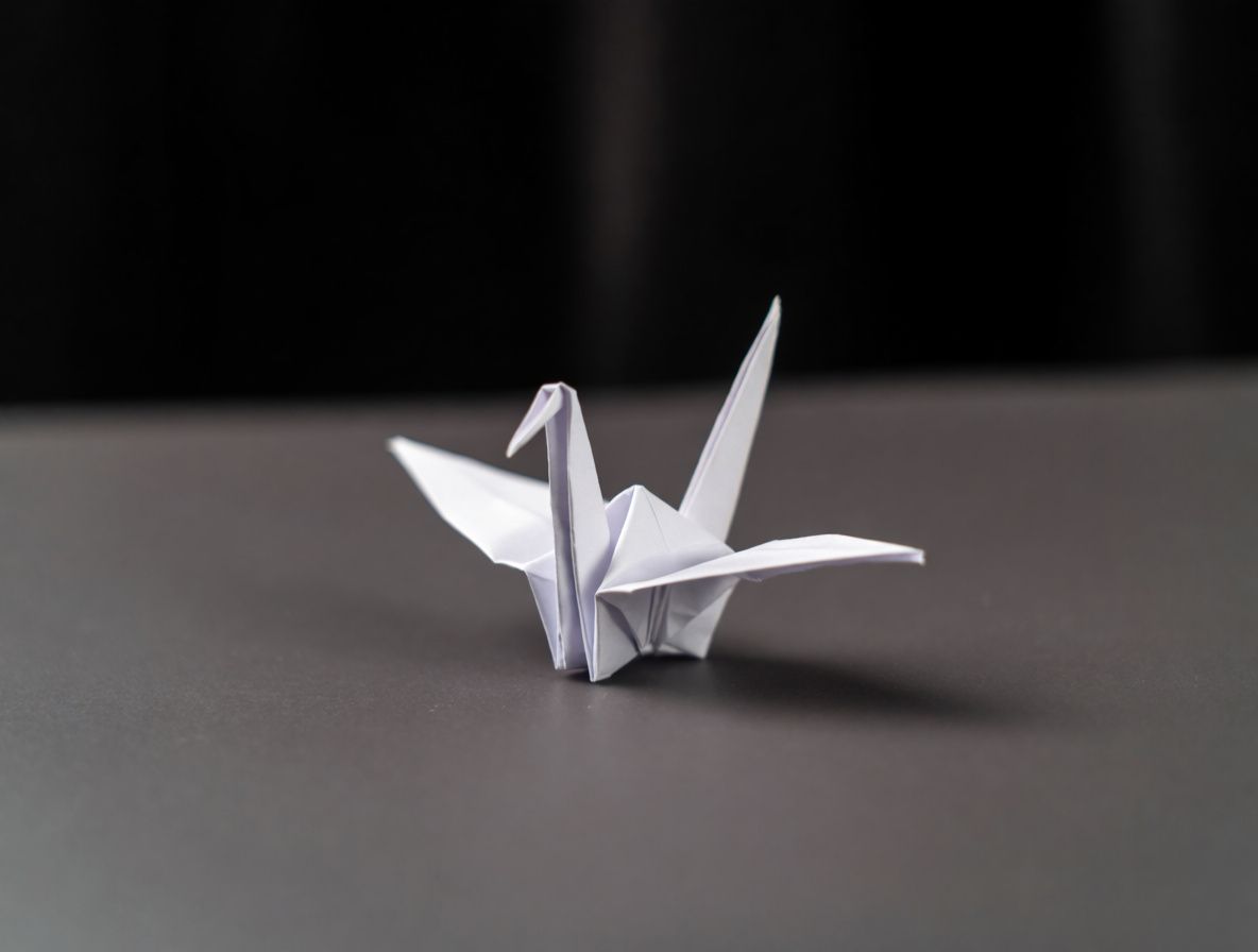 An origami crane on a dark surface without any style transfer applied