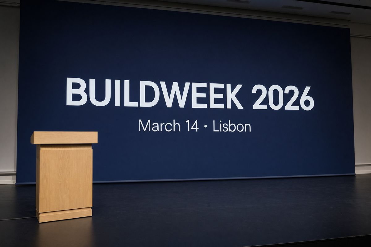 A navy conference backdrop with BUILDWEEK 2026 in heavy white capitals across two thirds of the panel and a thin date line beneath